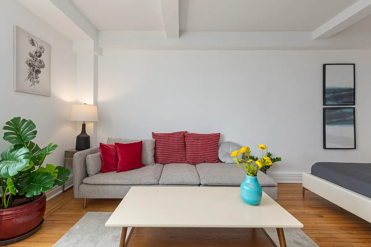 living room with a seating area and a bed