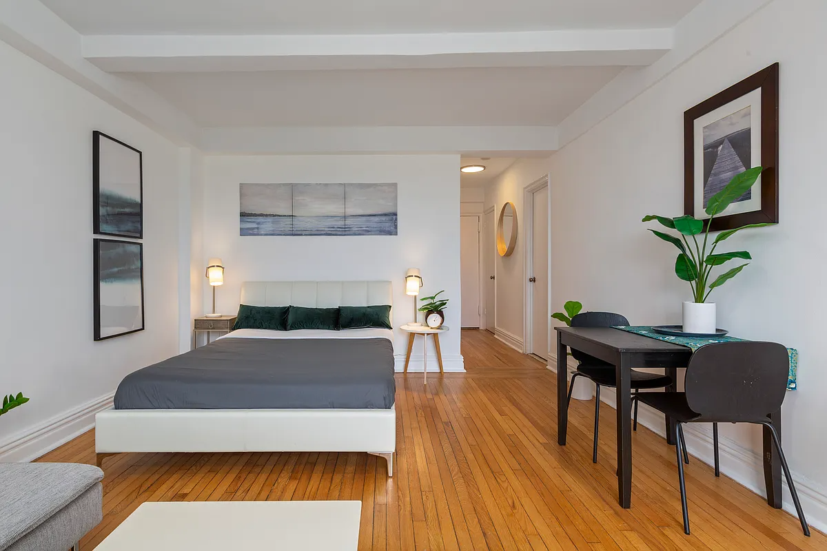 living space with wood floor and room for a bed