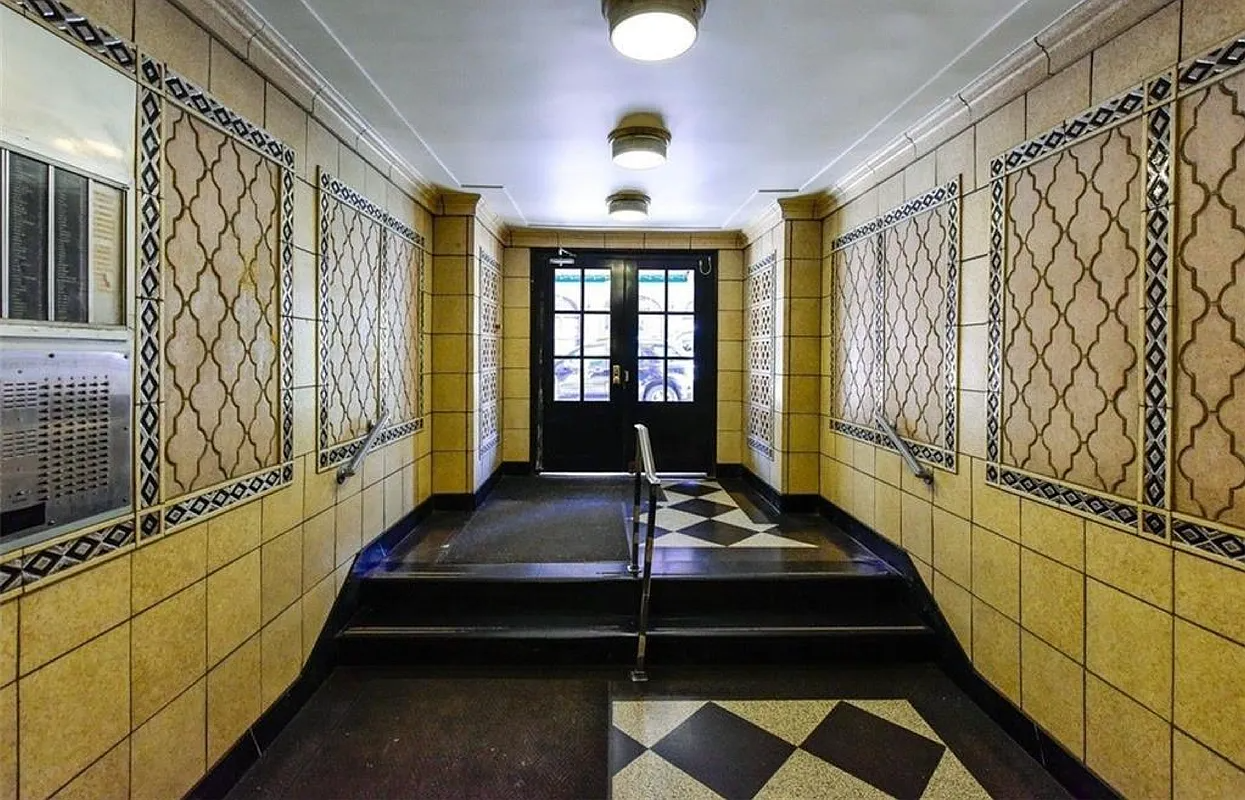 lobby entrance with tiled walls and a steps