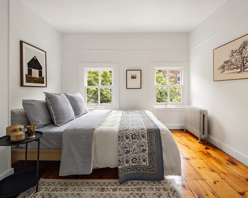 top floor bedroom with wide planked floorboards, white walls