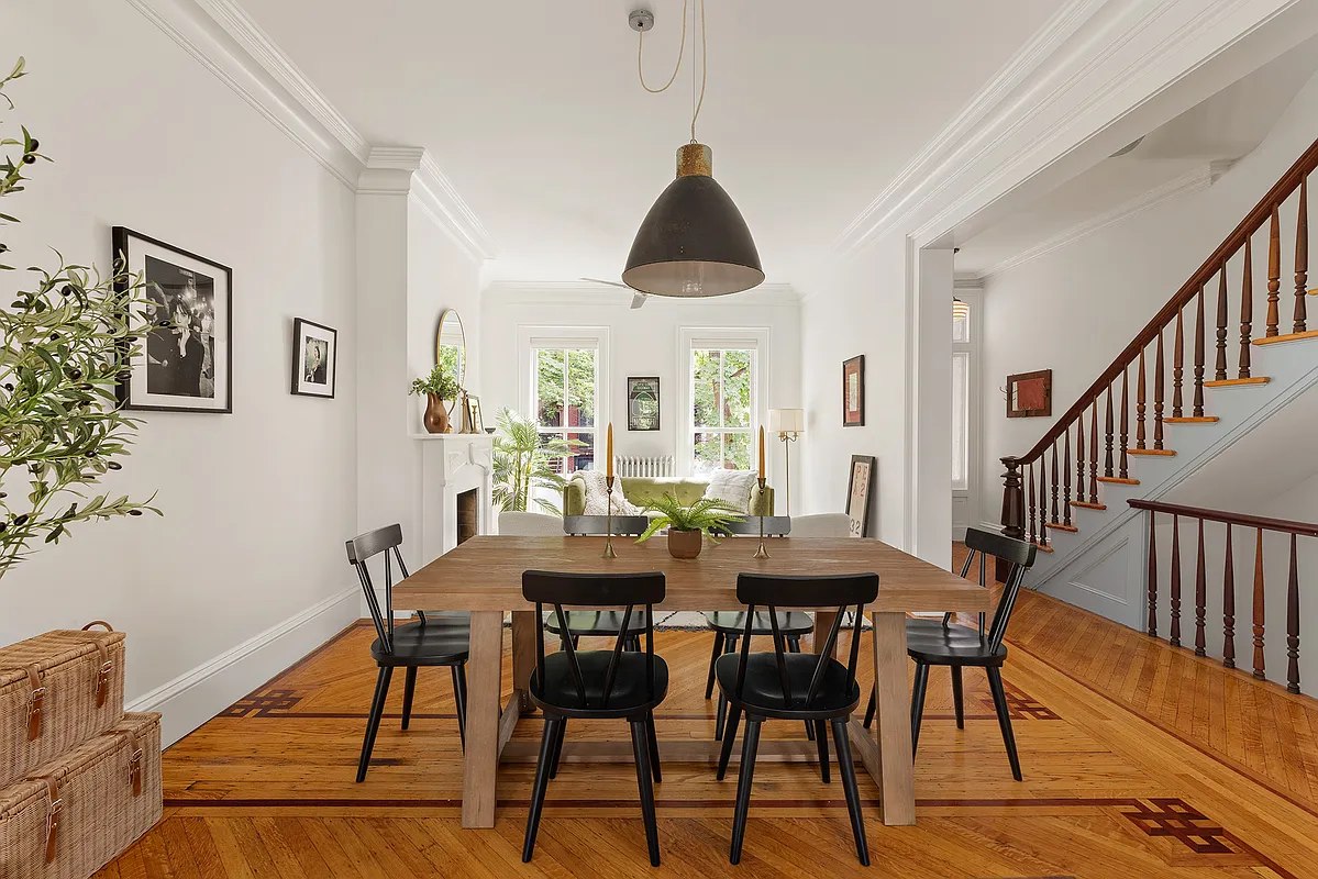 open plan living room and dining area with wood floor, view into the hall and the staircase