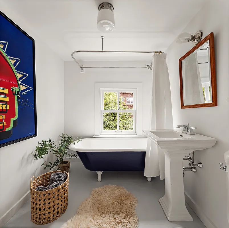 bathroom with a clawfoot tub painted blue