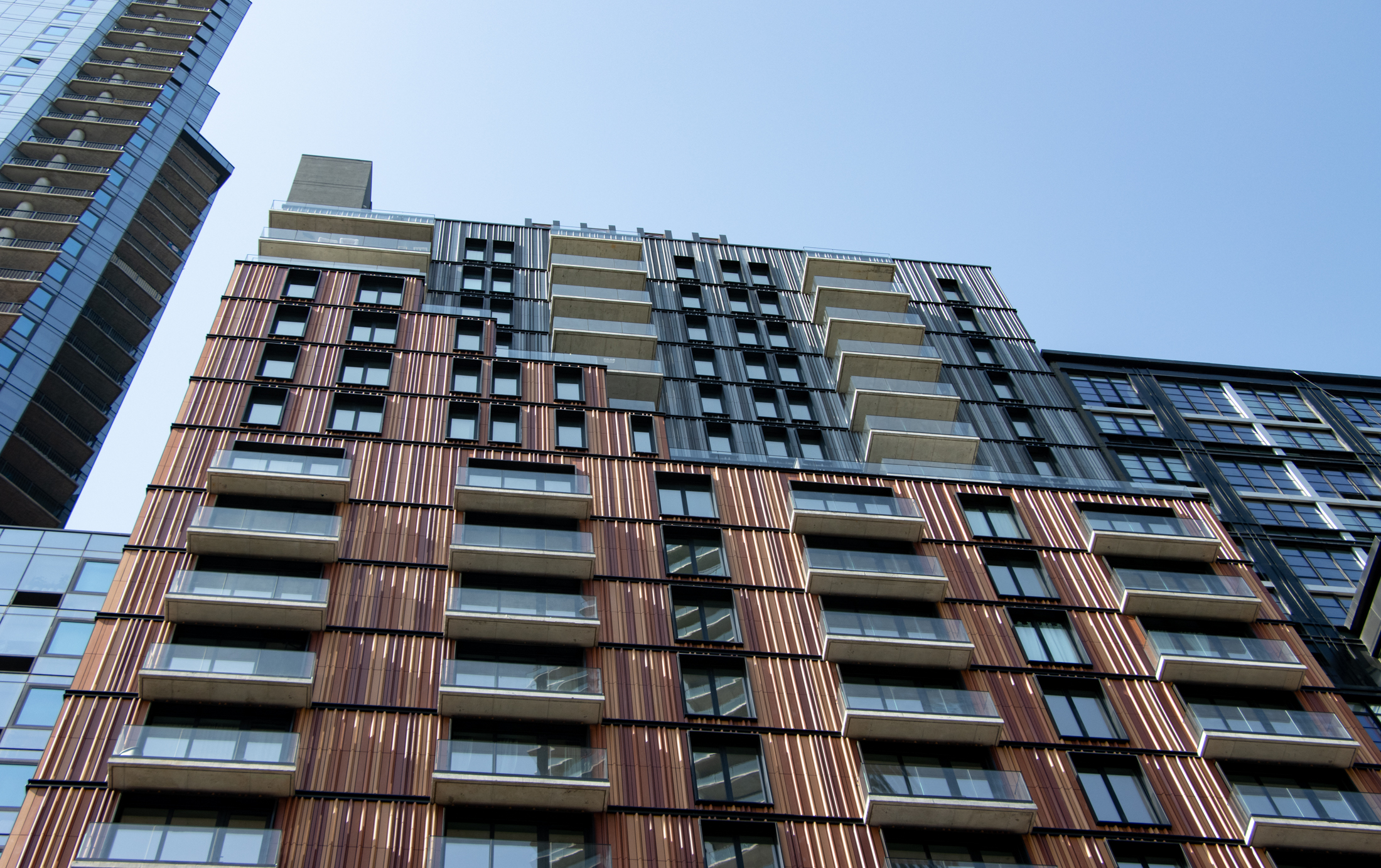 closeup of the upper floors of a multi-story building with balconies