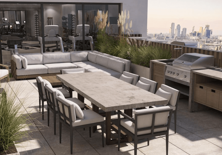 a roof deck with seating and a dining table