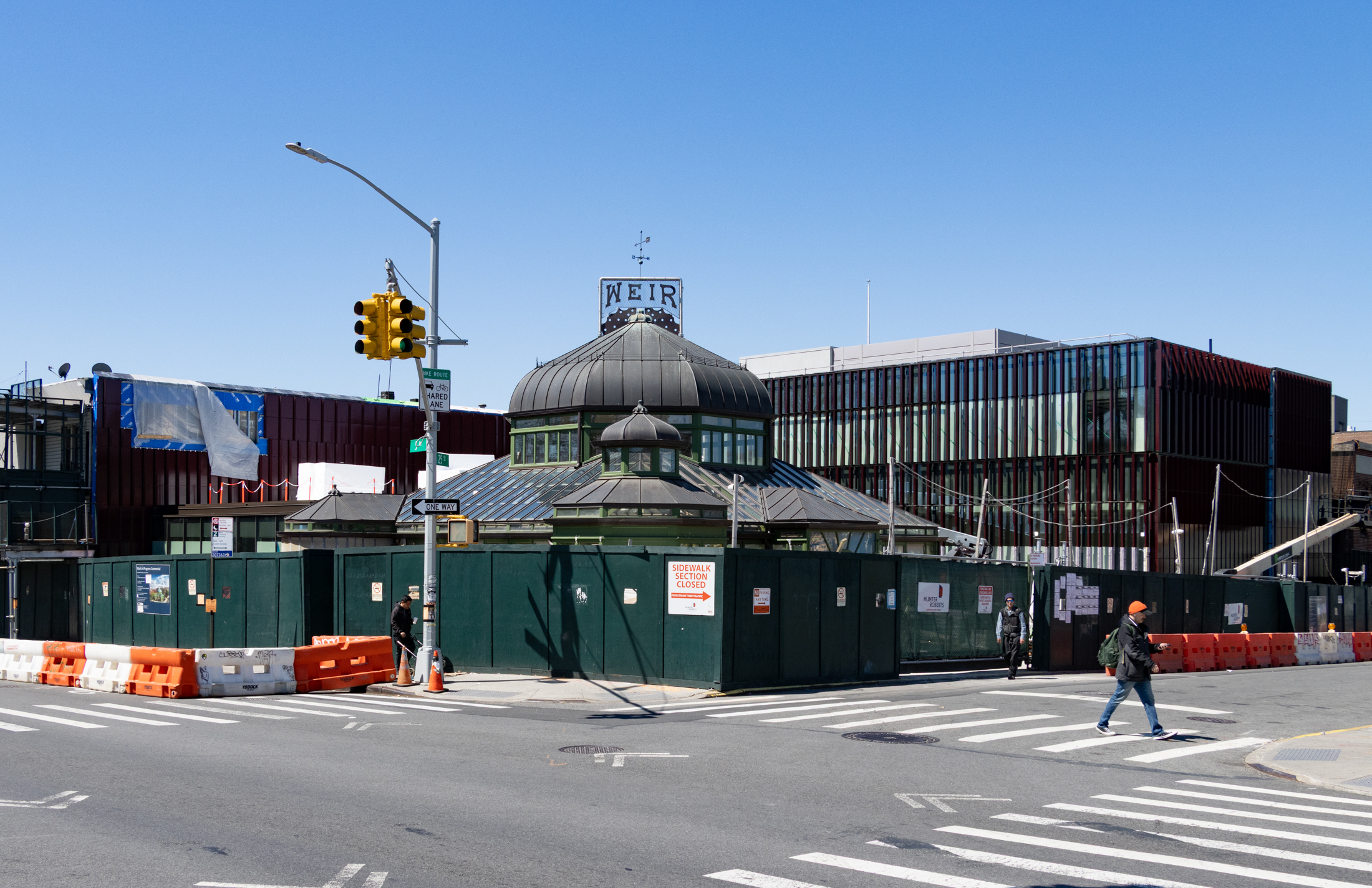 construction fence surrounding the greenhouse and new construction