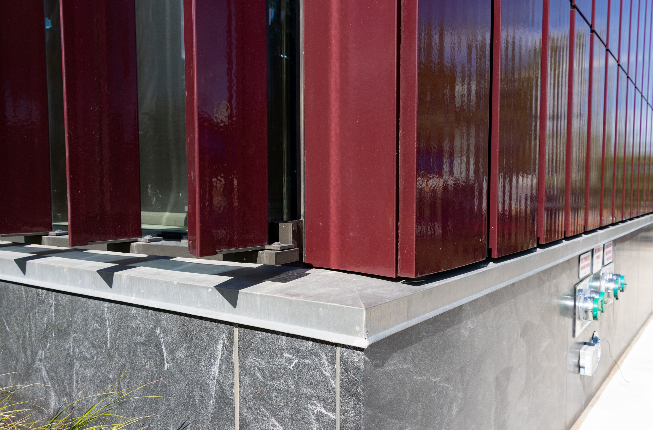 a corner of the new building showing the panels on the facade