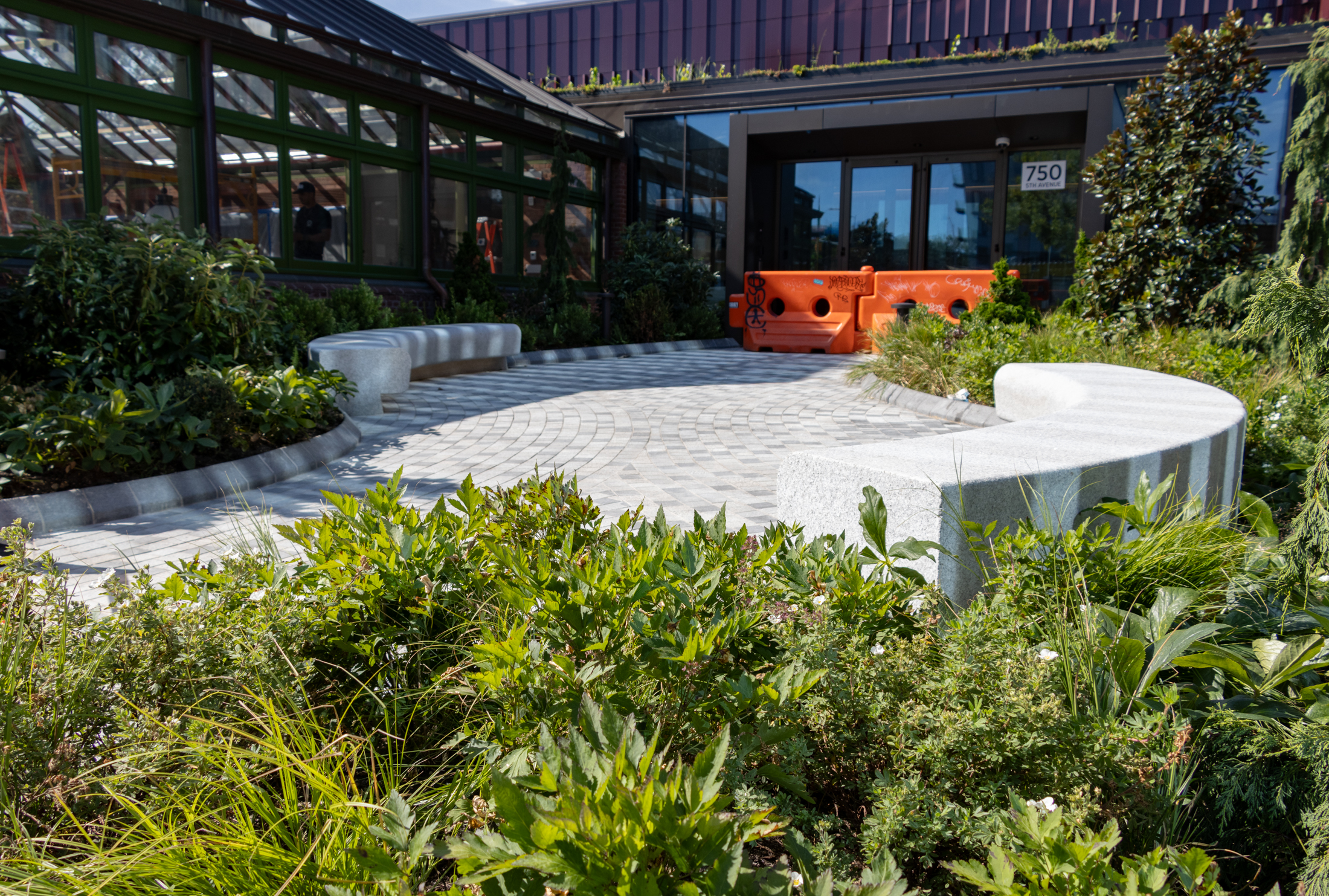 the main entry with curved benches and landscaping