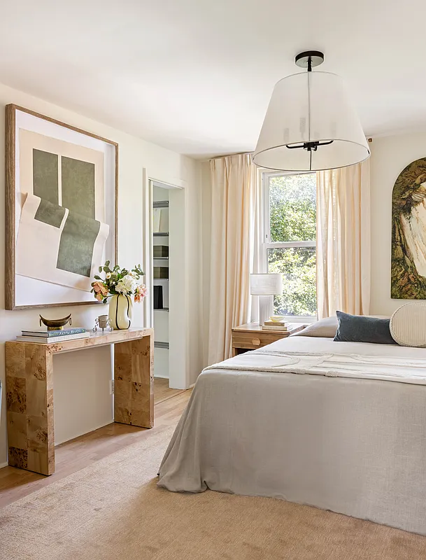 bedroom with cream walls, pale wood floor
