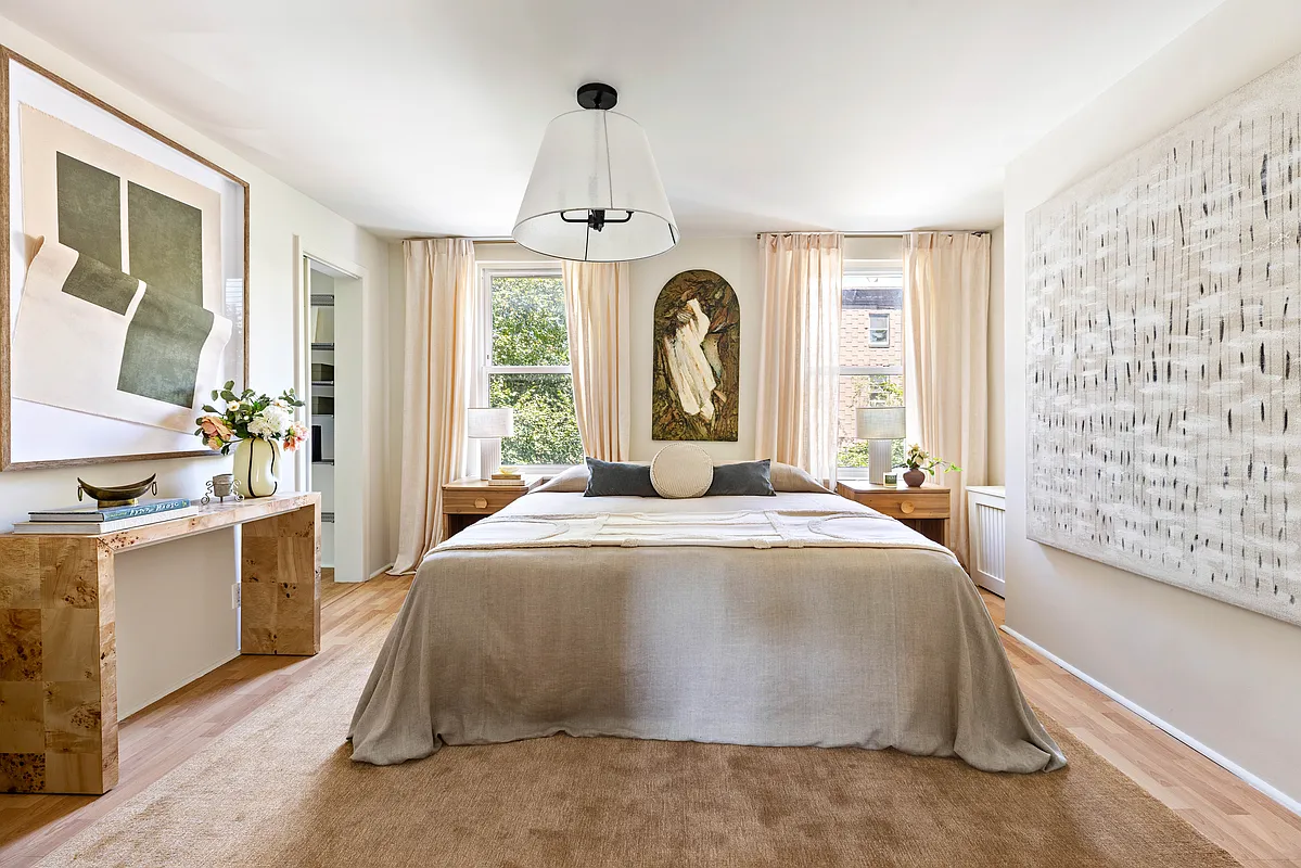 bedroom with two windows, pale wood floor