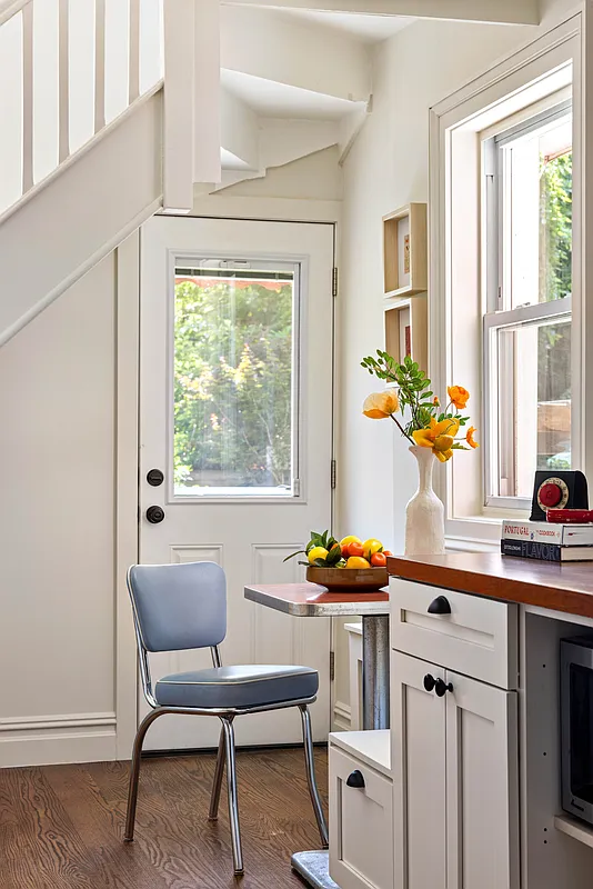 rear of kitchen room for a tiny table and single chair in front of a door to the rear yard