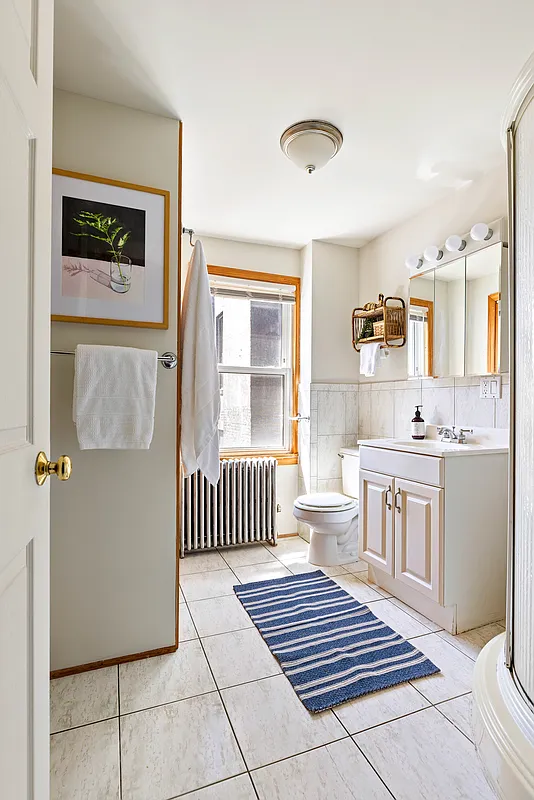 bathroom with tile floor, corner shower