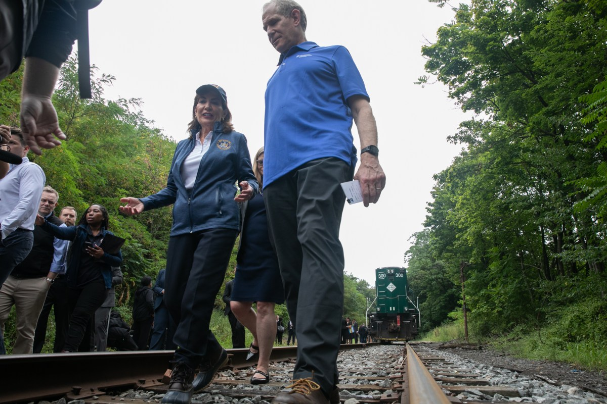 Gov. Kathy Hochul and MTA Chair Janno Lieber walk along tracks in Borough Park slated to become part of the Interborough Express, Aug. 1, 2025.