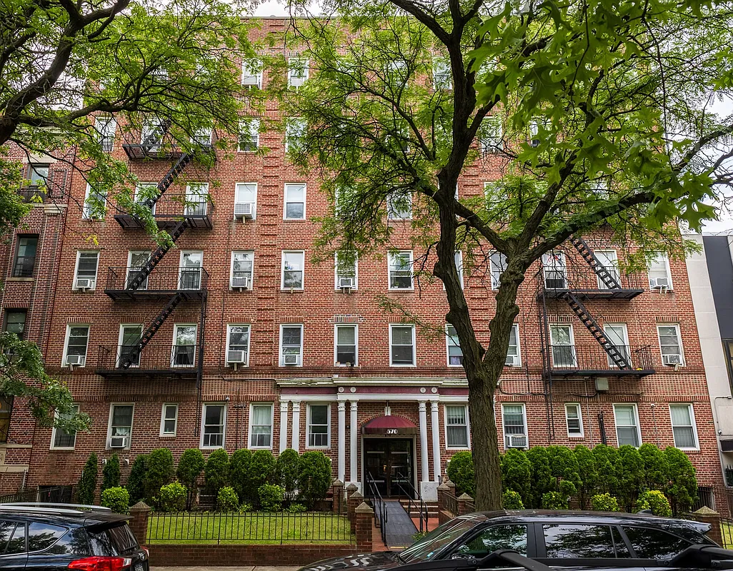 red brick apartment building with columned entry