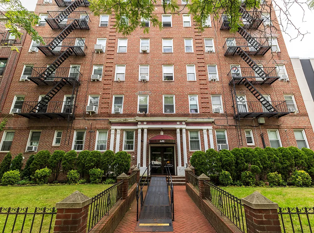 red brick apartment building with columned entry