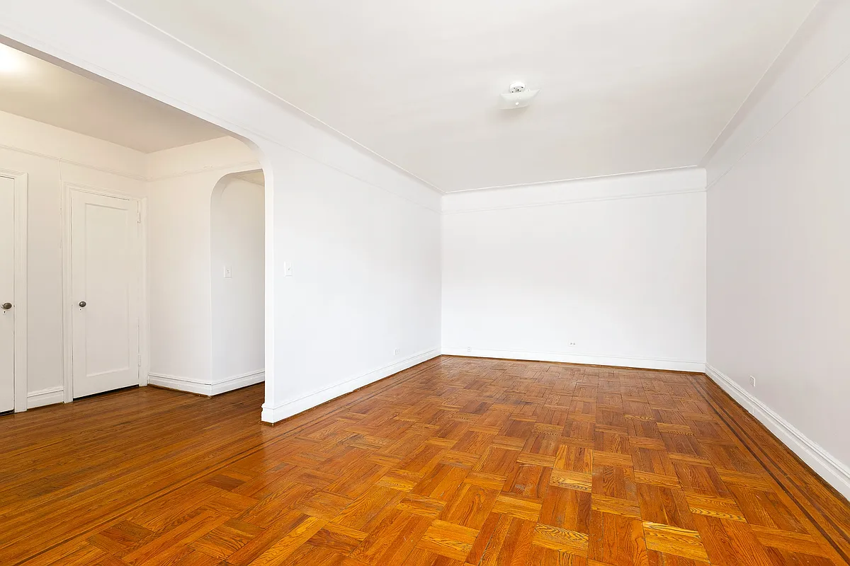 living room with wood floor, picture rail, white walls