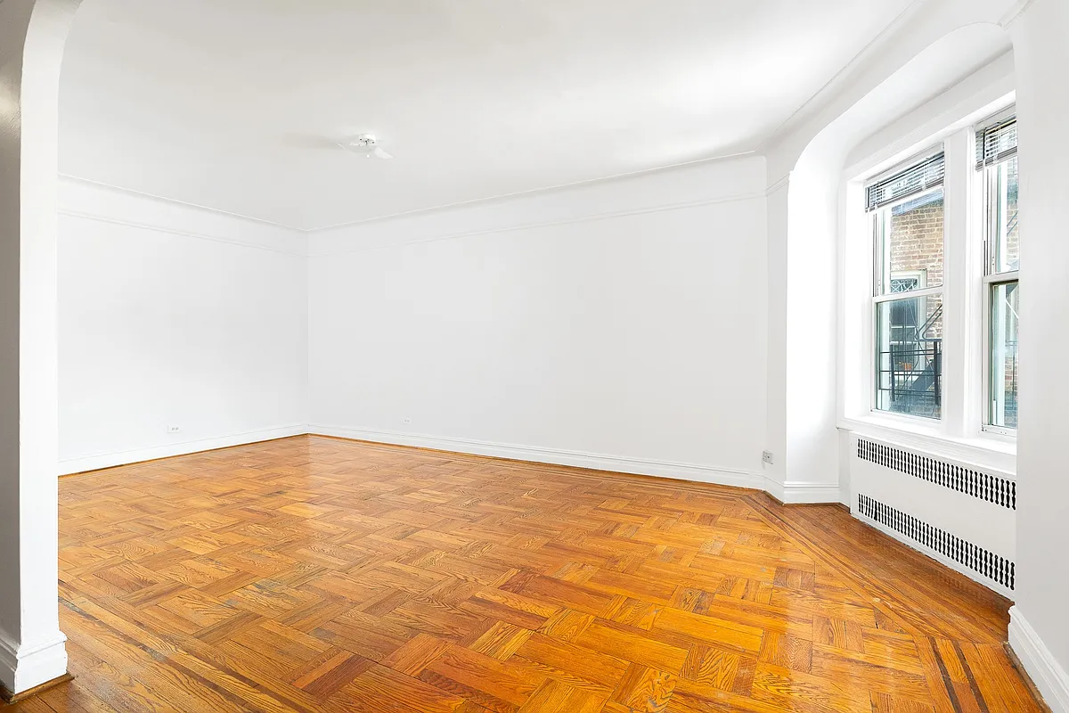 living room with windows in corner, wood floor