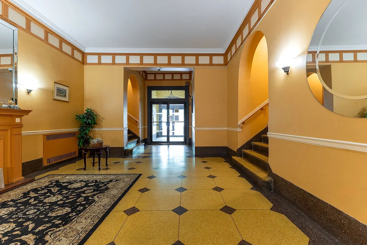 building lobby with yellow walls, decorative mantel