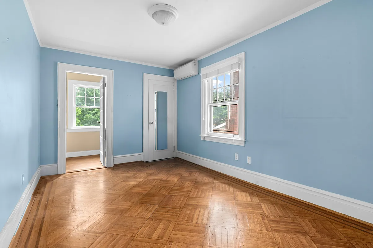 bedroom with wood floor, blue walls