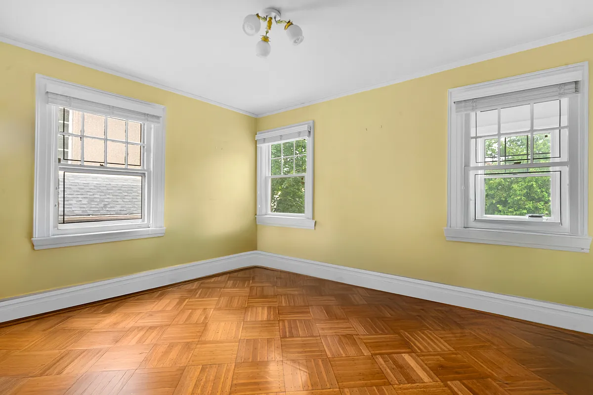 bedroom with yellow walls, wood floor