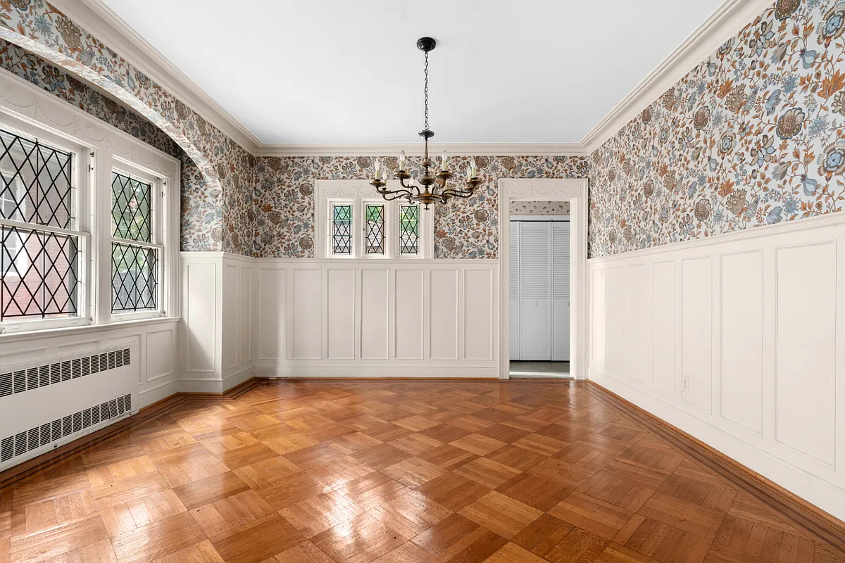 dining room with wainscoting, floral wallpaper, wood floor