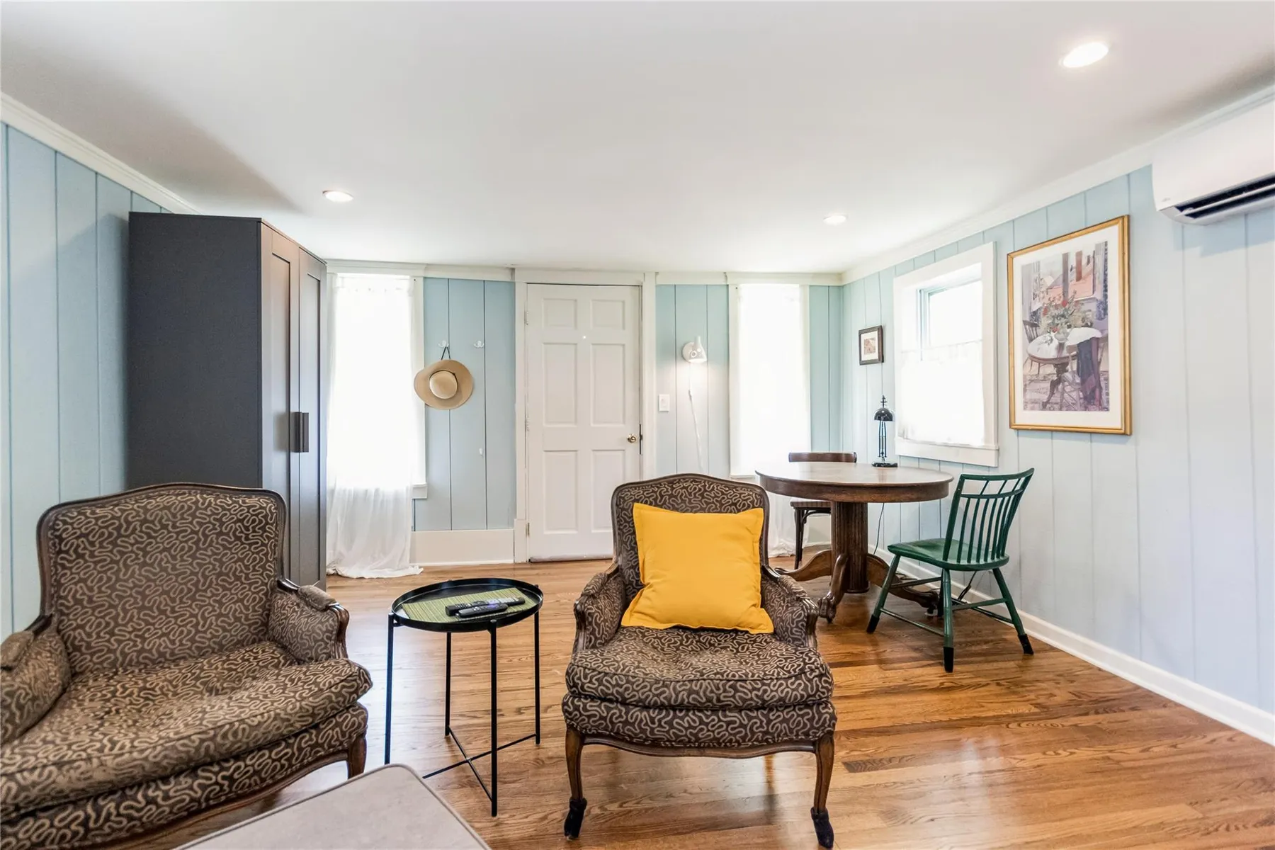 living room with recessed lighting, mini split on wall, wood floor