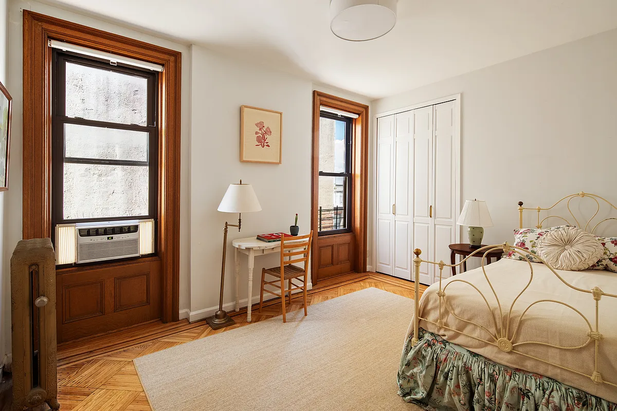 bedroom with two windows, wood floor