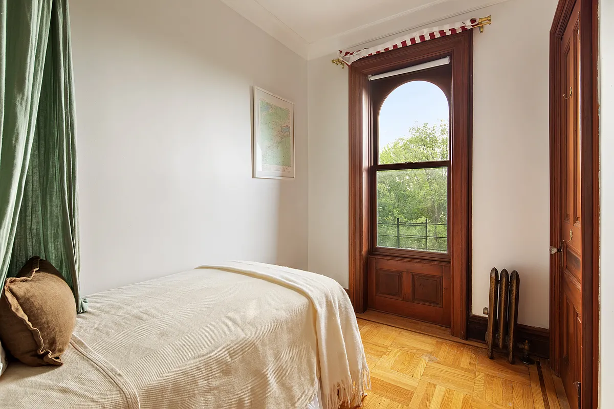 bedroom with wood floor, wood moldings