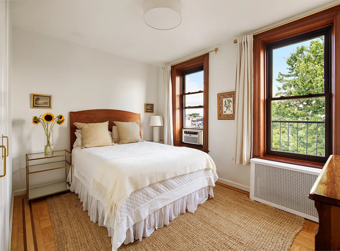 bedroom with two windows, wood floor