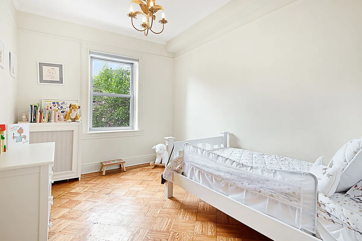 bedroom with wood floor, room for a twin bed