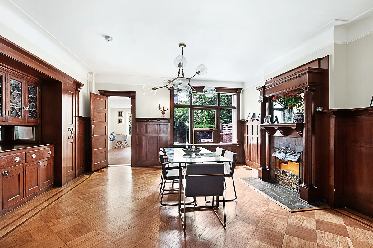 a dining room with built-ins, a mantel