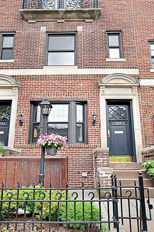 red brick exterior with a low stoop and concrete terrace