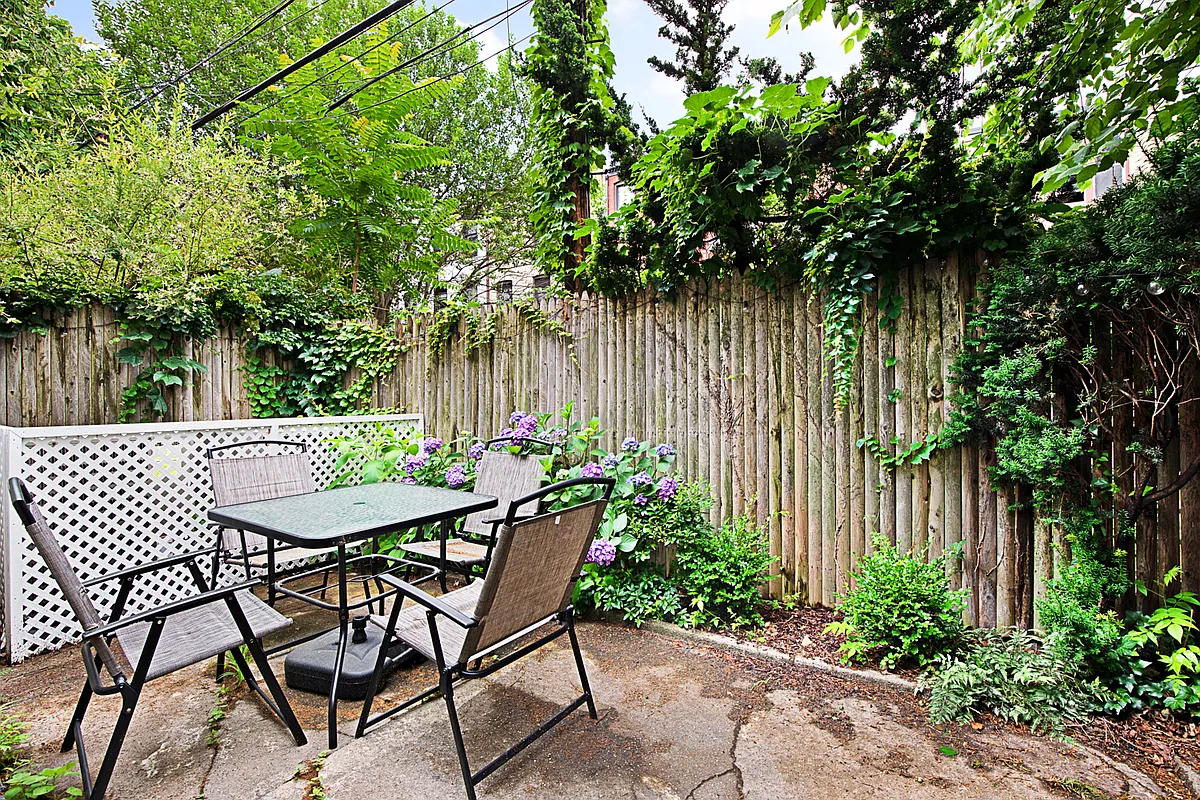 rear yard with concrete patio and some plants