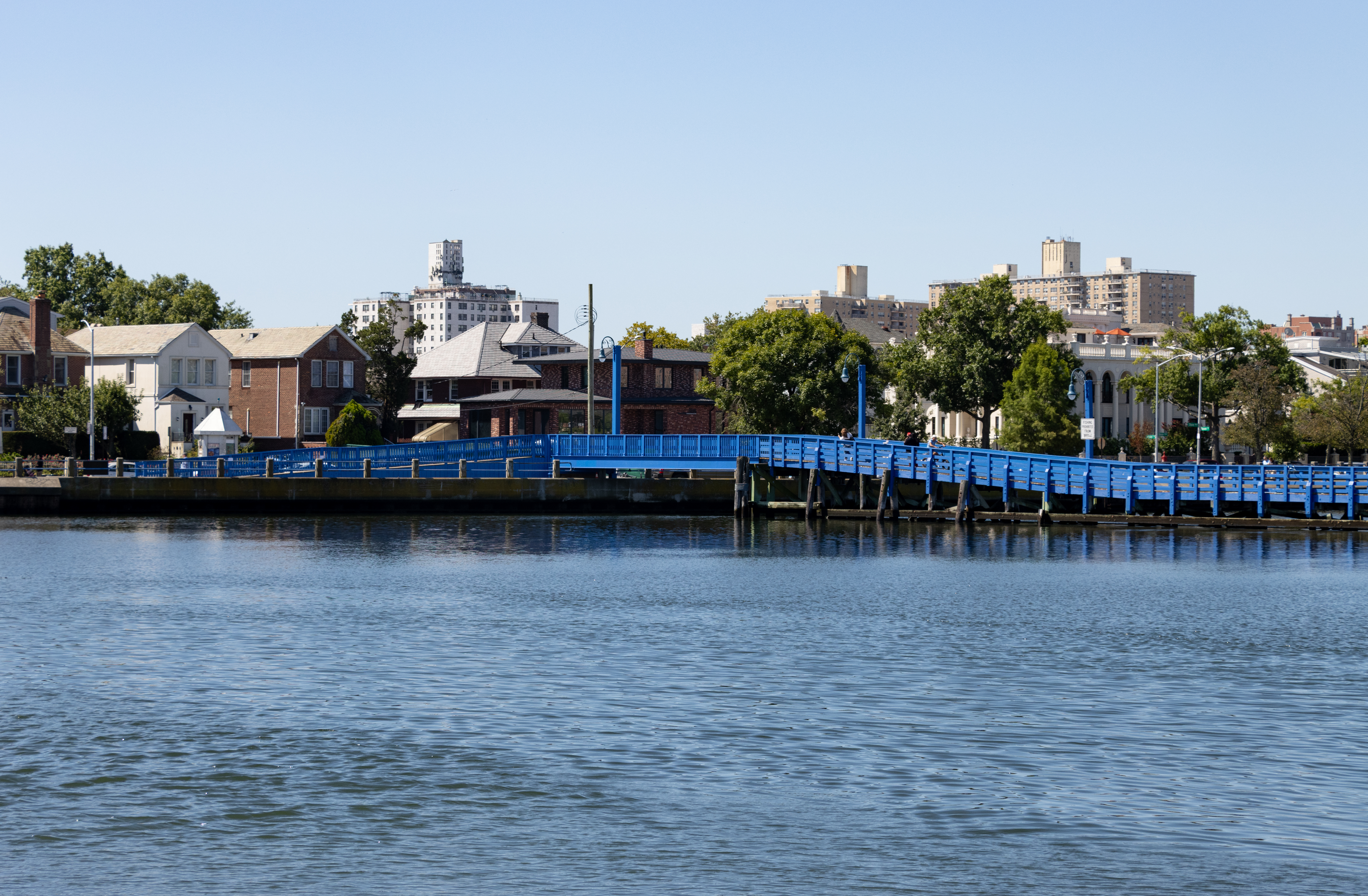 a blue bridge stretching over the water