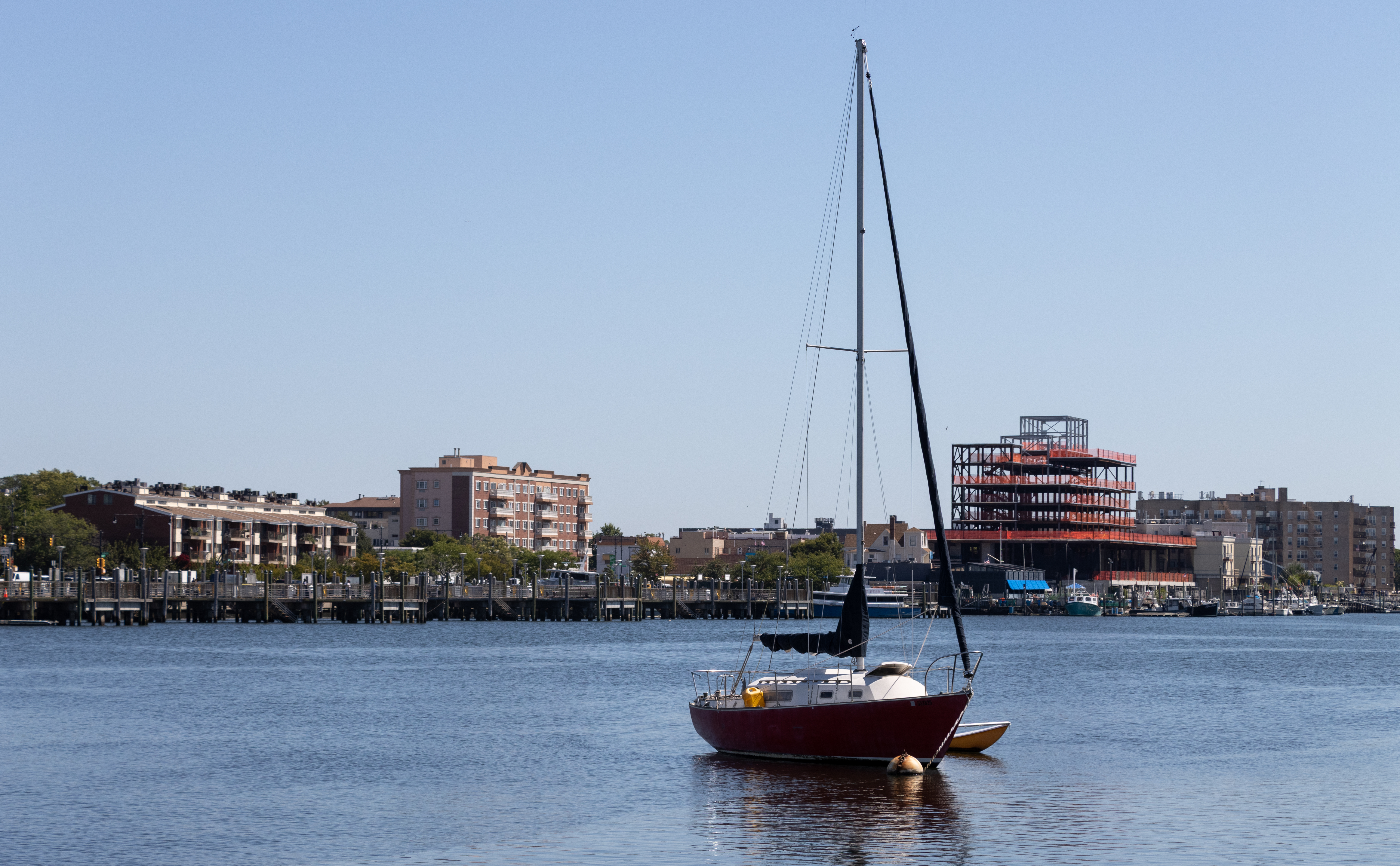 boat on the water and building under construction beyond