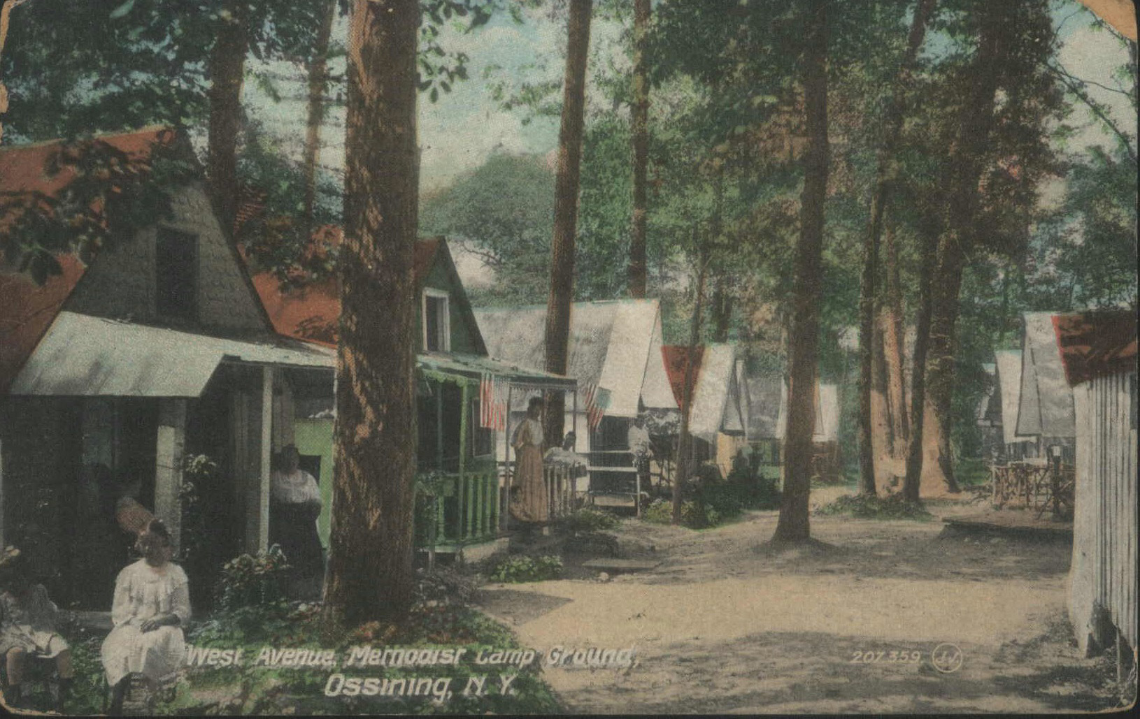 postcard showing rows of simple wood cottages in the early 20th century