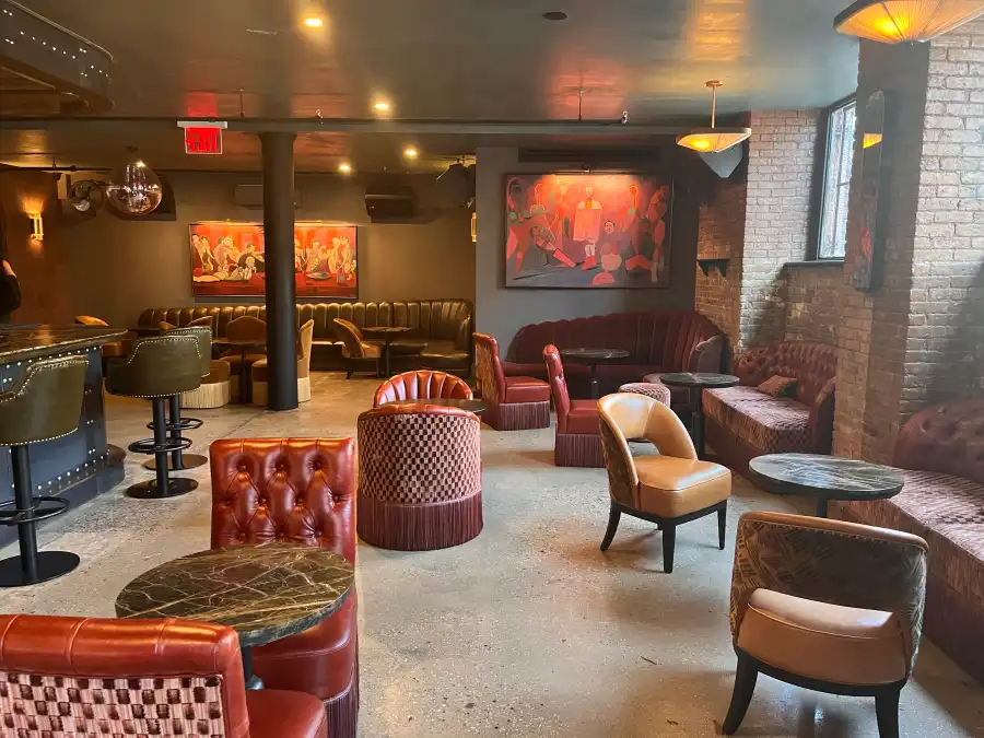 interior with lounge chairs, banquettes and round tables