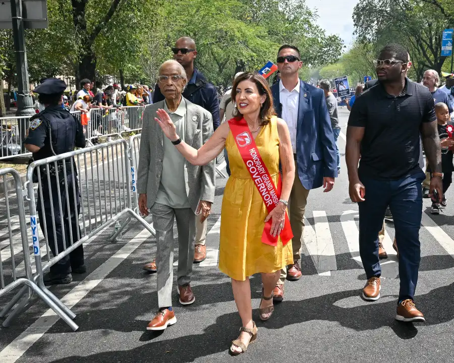 Rev. Al Sharpton (at left) and Gov. Hochul marched in the parade.