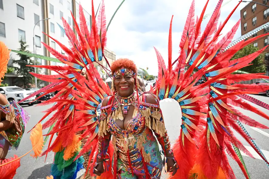 person in vibrant red costume with feathers