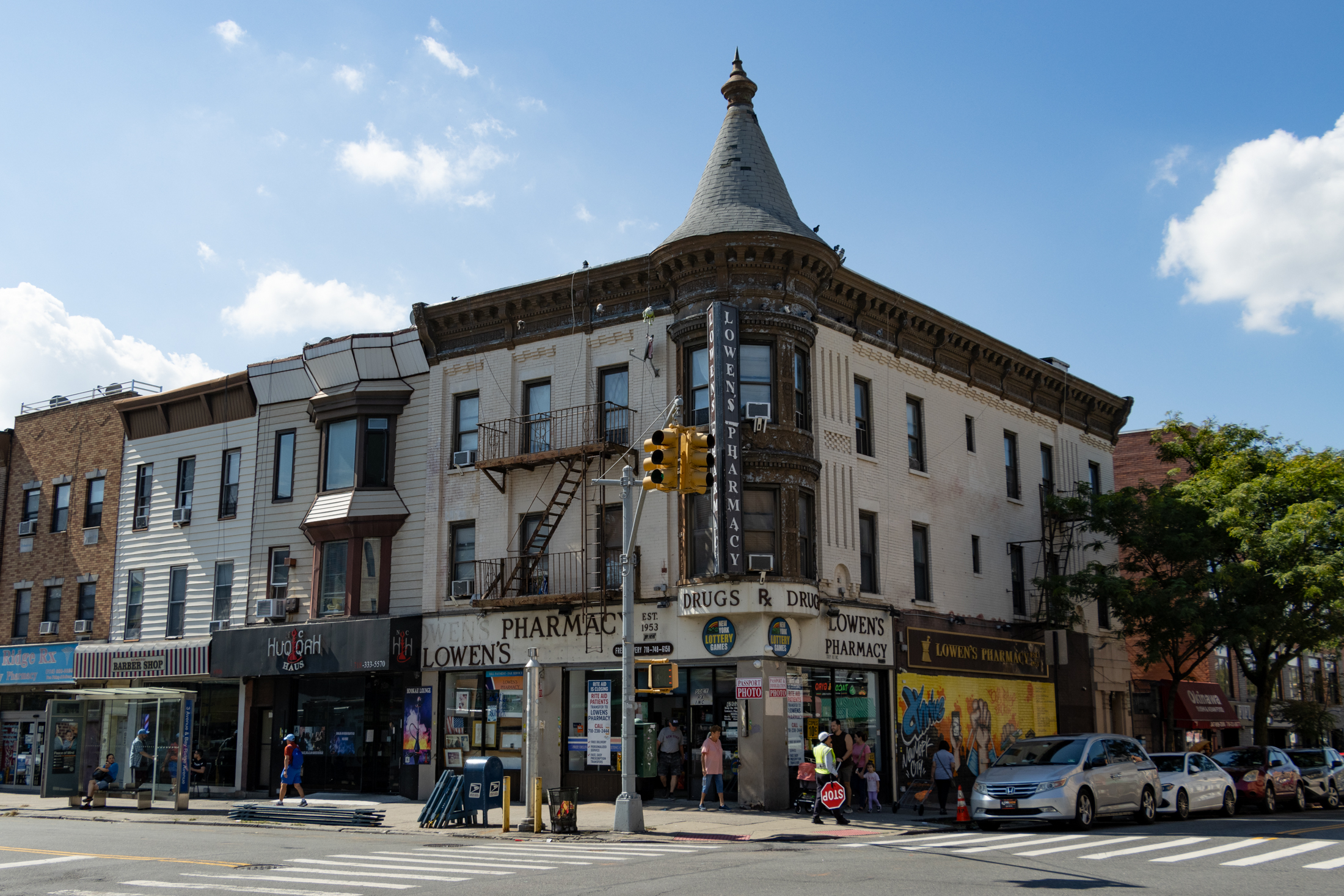 a 19th century commercial building with a turret with a conical roof