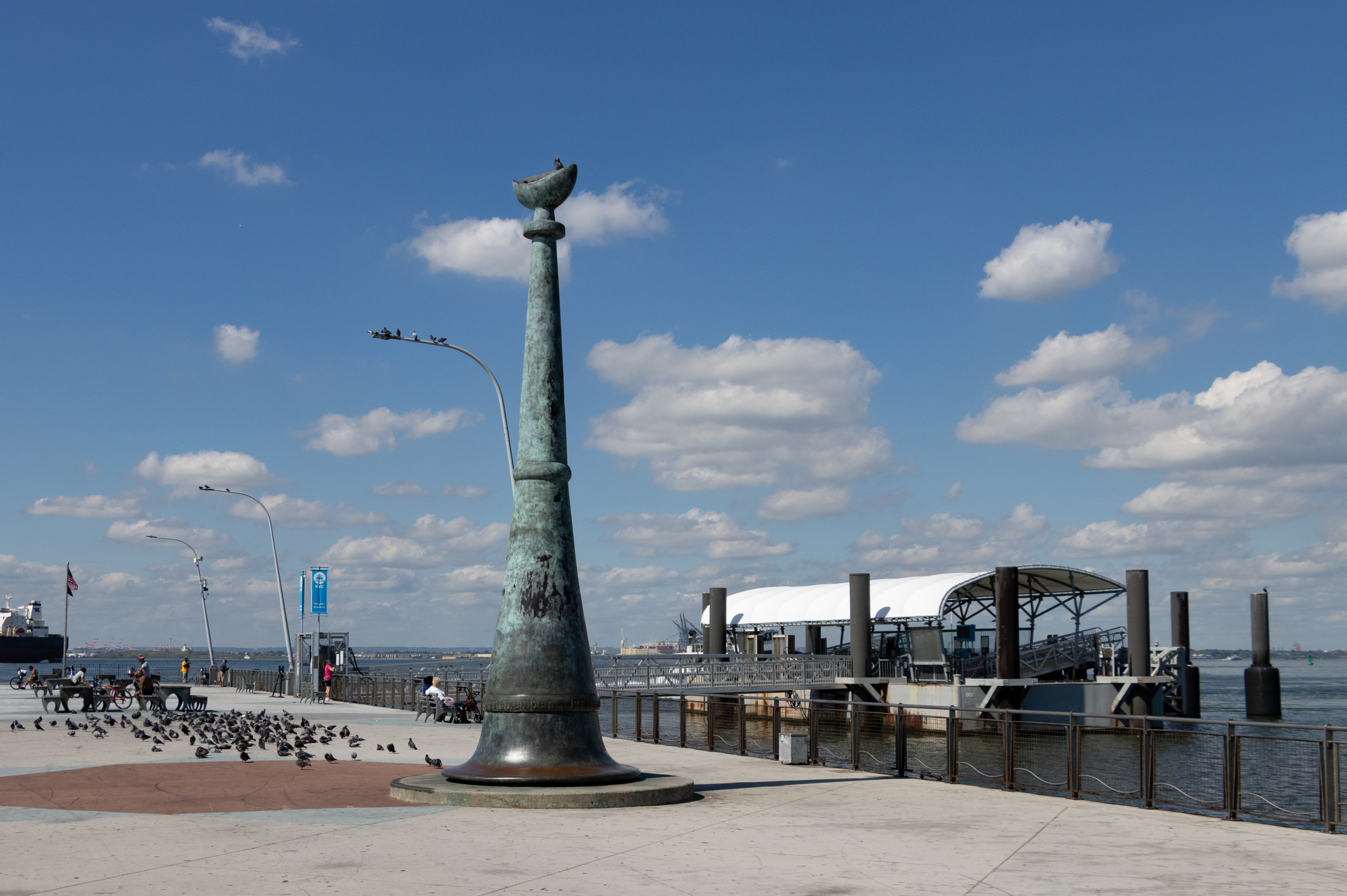 pier in bay ridge with a ferry landing and a large sculpture with a green patina