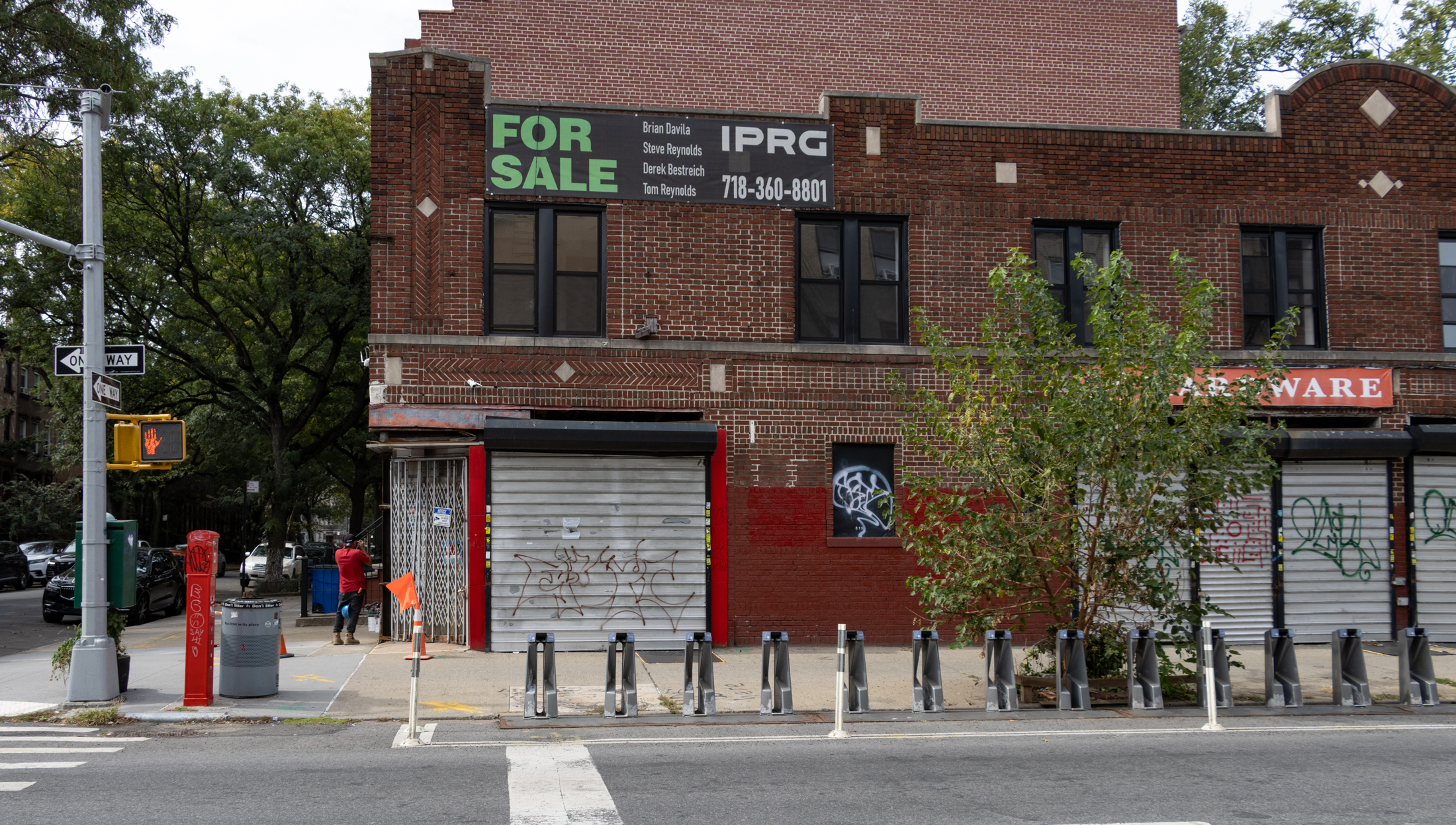 brick building with security gates on the side facade