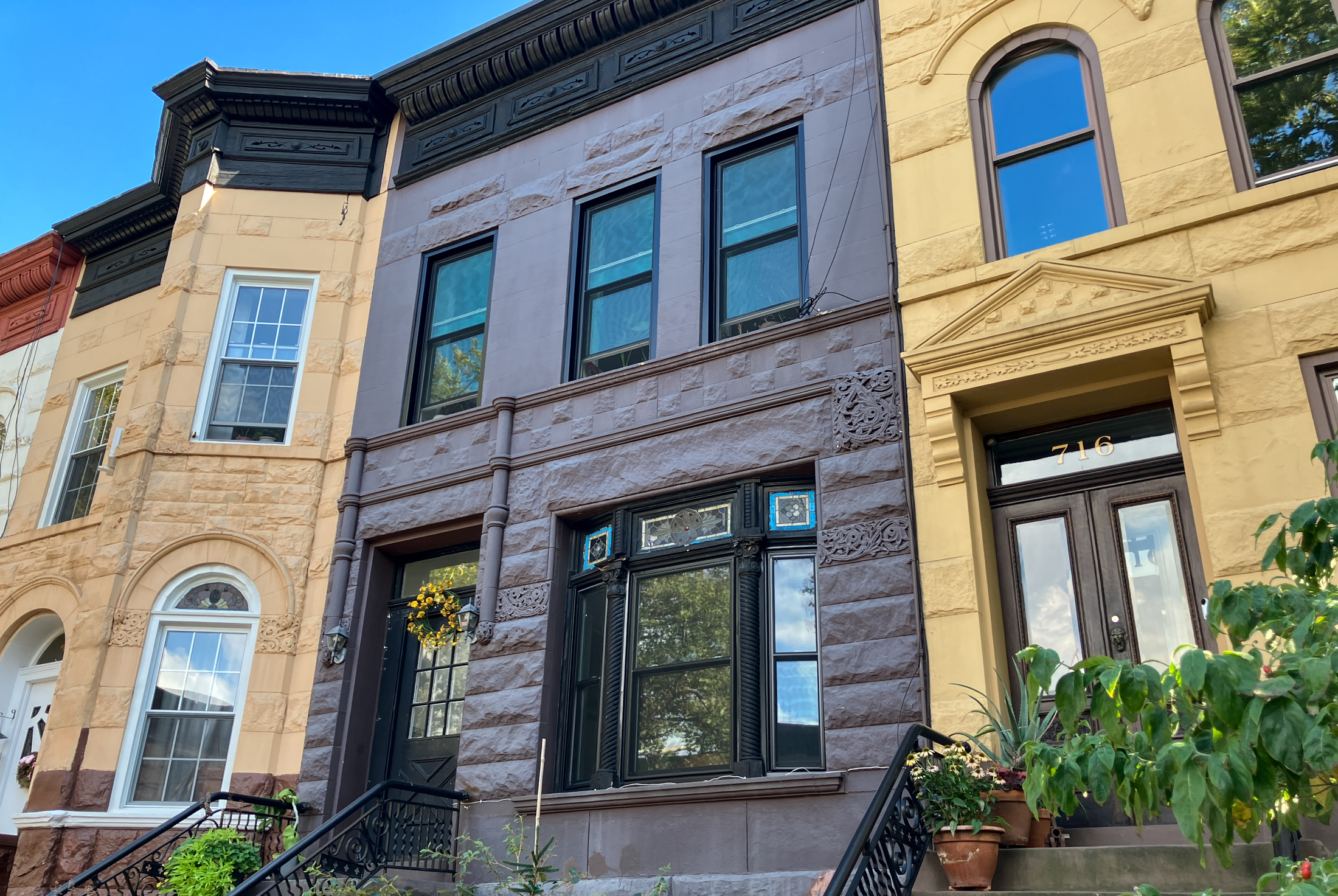 colorful row houses with plants on their stoops