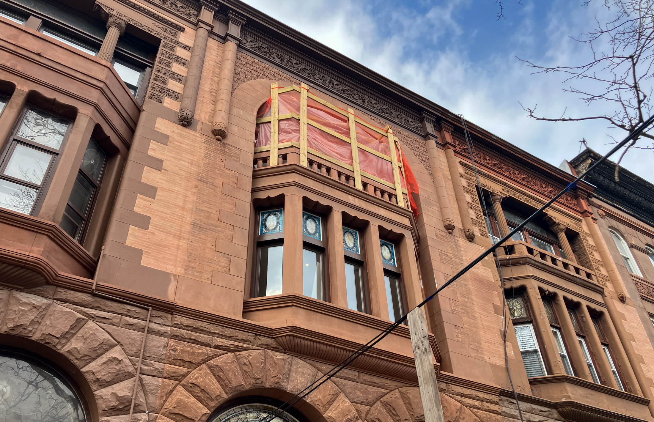 brownstone with orange netting on window