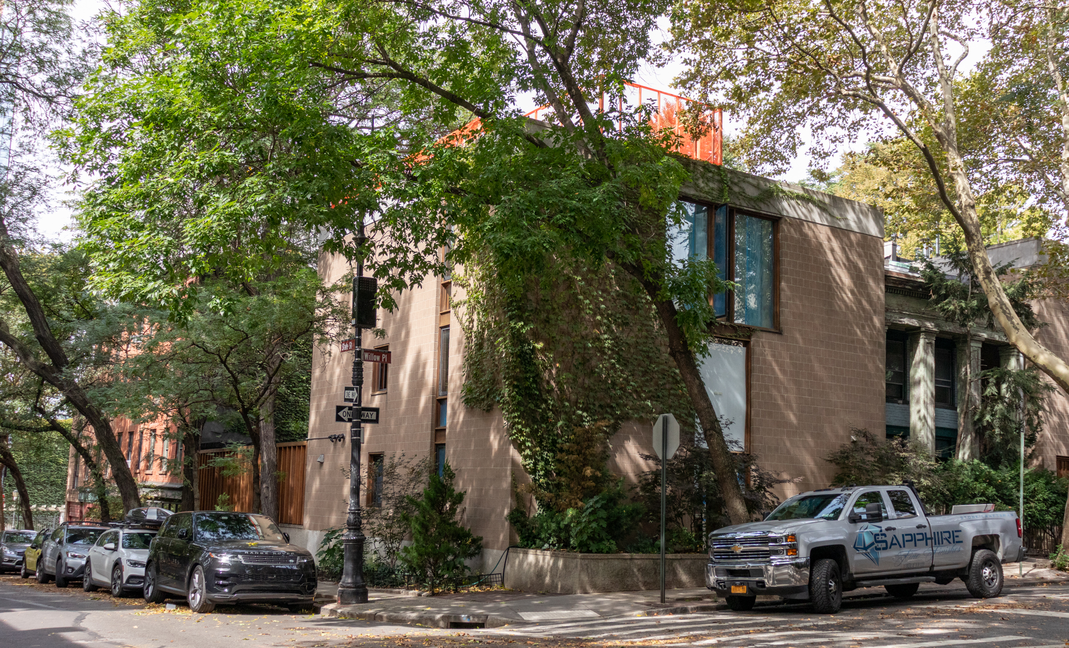 mid century row house with orange netting on roof