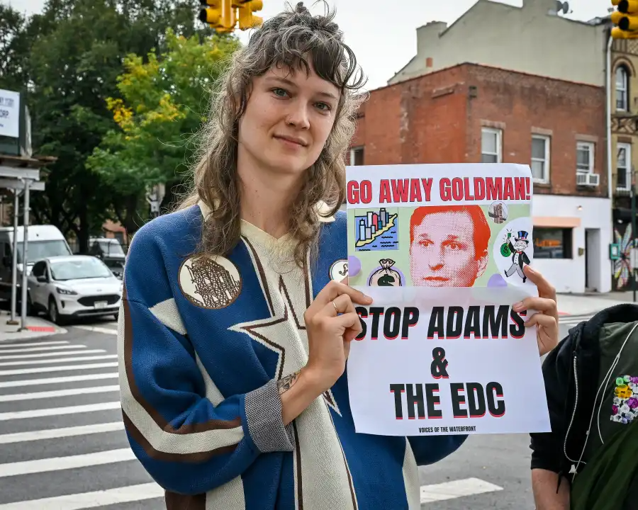 person holding a protest sign