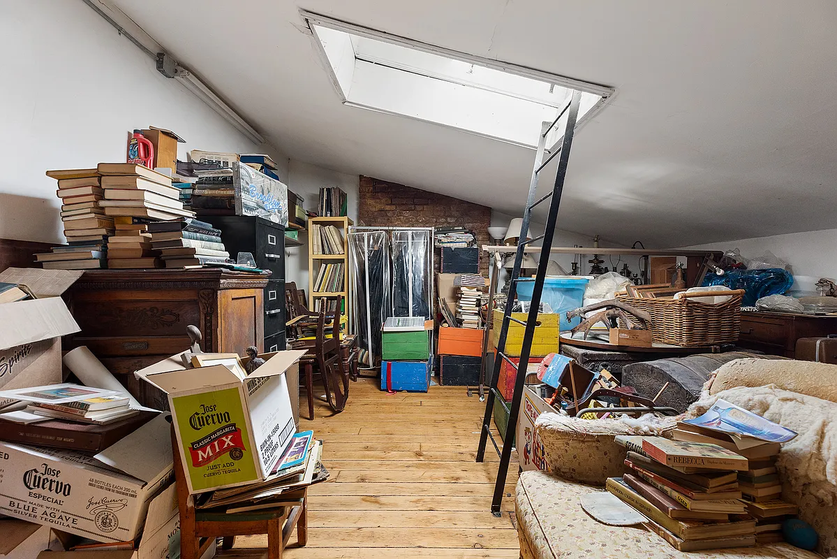 attic storage area with ladder to hatch