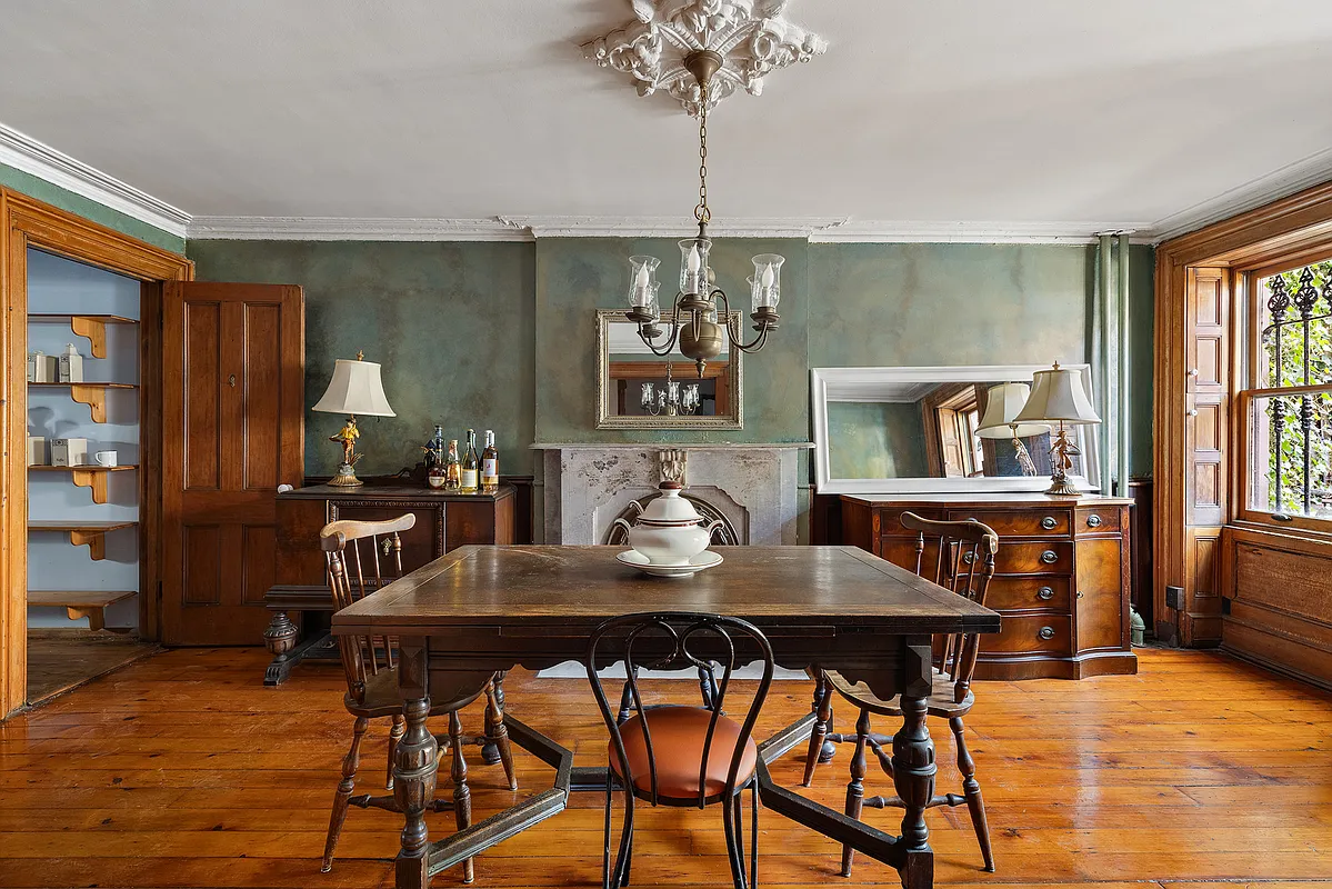 dining room with green walls, wood floor, marble mantel, ceiling medallion