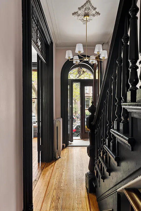 front entry hall with a ceiling medallion, stair, arched doorway