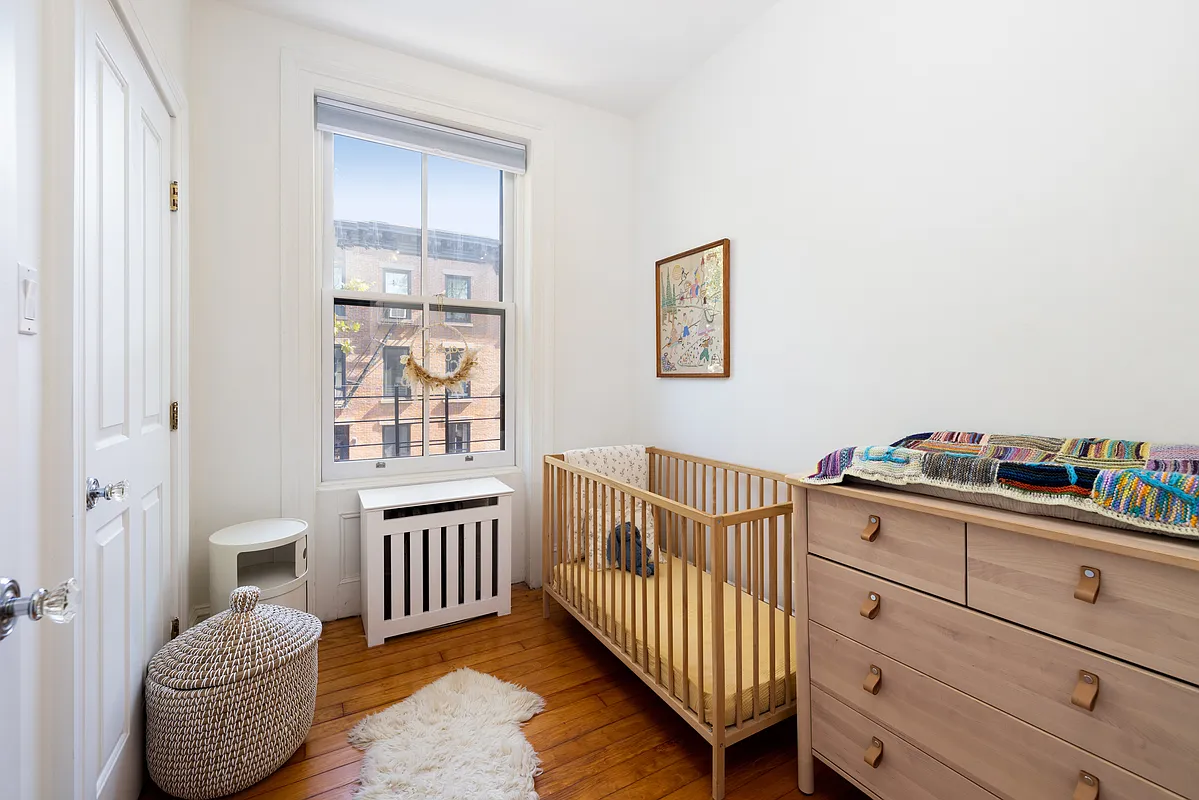 narrow bedroom with room for a crib