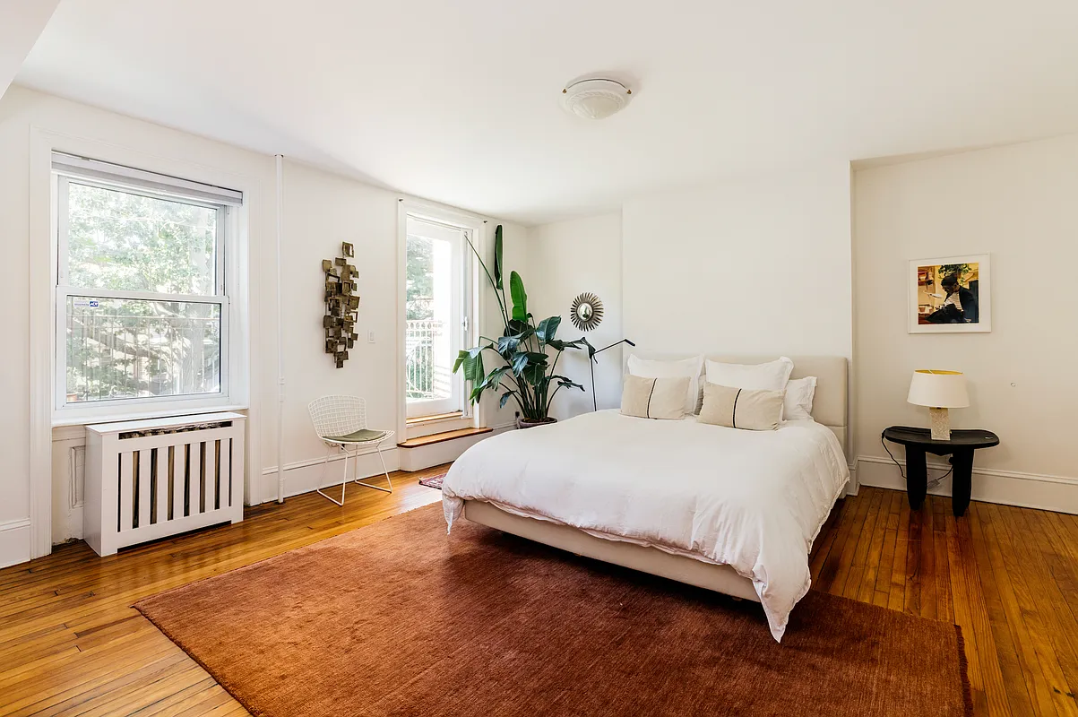 bedroom with wood floor, door leading to a rear terrace